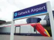 Gatwick Express train in station, Gatwick Airport sign