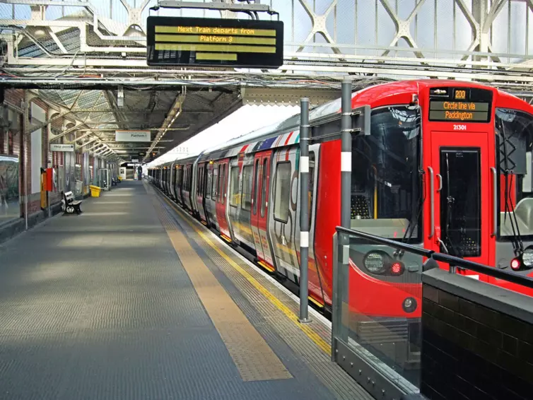 red underground train in station.