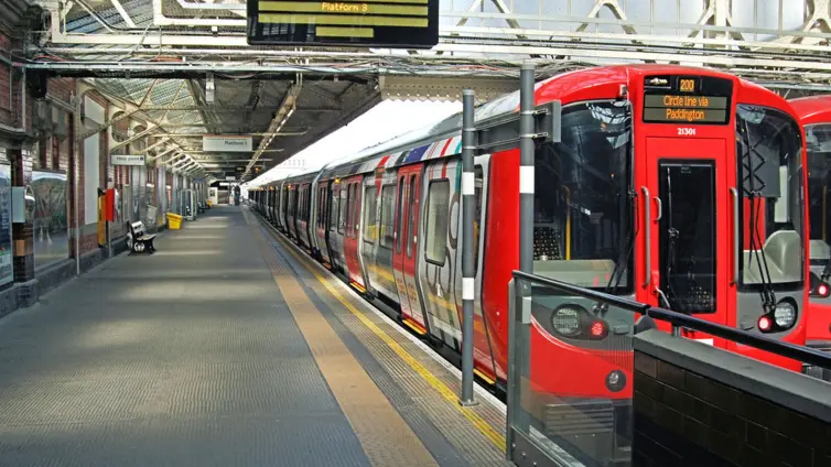 red underground train in station.