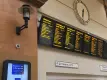 Train information boards and clock in train station