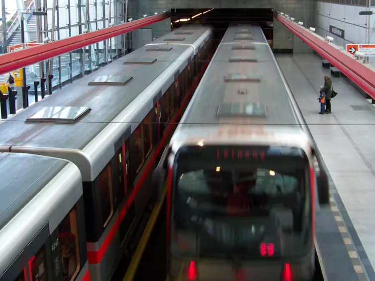 2 Prague metro trains, side by side in a station.