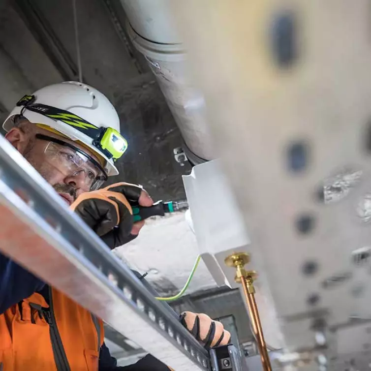 engineer at work, installing telecoms equipment.