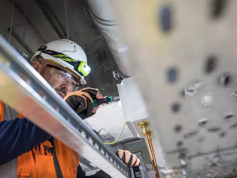 engineer at work, installing telecoms equipment.