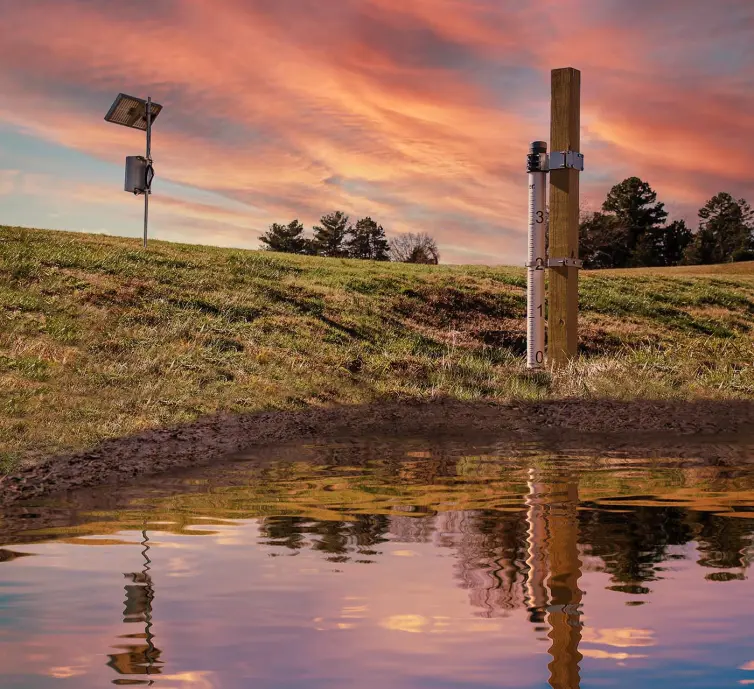 flood monitoring pole with solar panel measuring water levels.