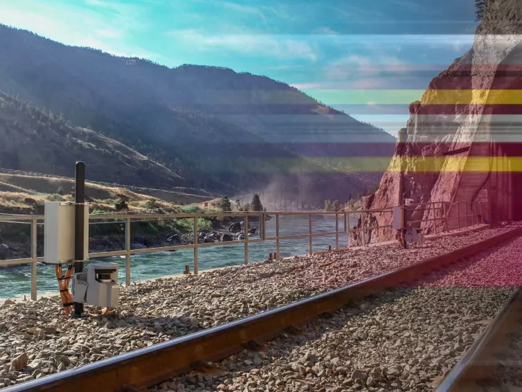 tracks with rockfall monitoring systems next to a waterway.