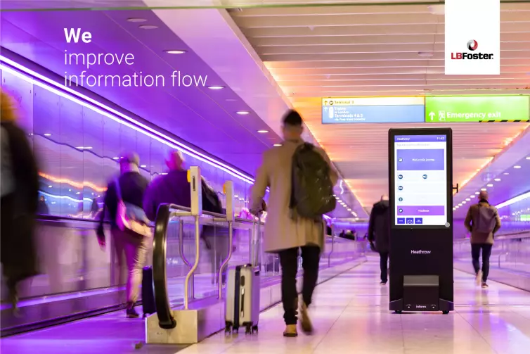 Blurred people in motion walking down a walkway and on a travelator in an airport. A freestanding Inform totem is on the right displaying journing information screen. Text on the image says 
