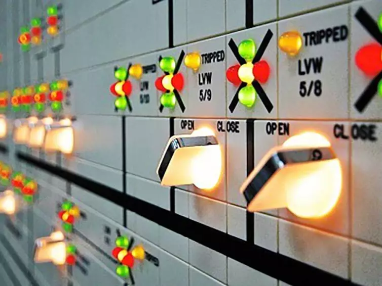 close-up of a control panel with multiple colorful buttons lit up.