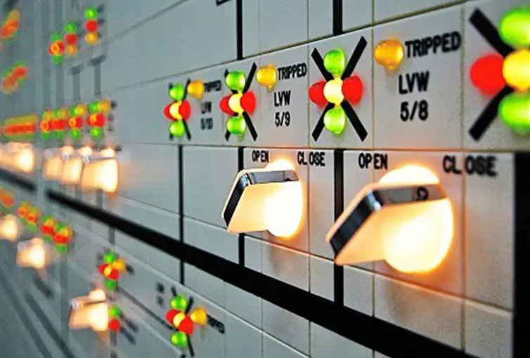 close-up of a control panel with multiple colorful buttons lit up.