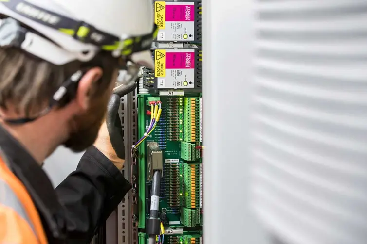 man fitting station electrical equipment.