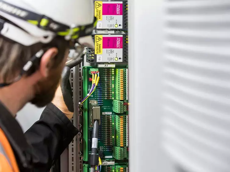 man fitting station electrical equipment.