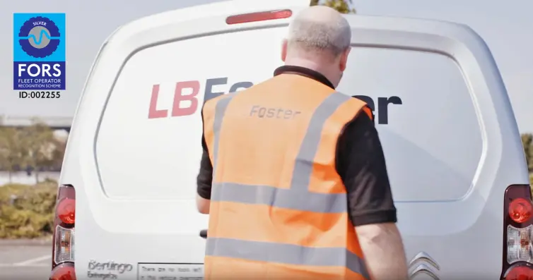 Man in hi-vis closing a LB Foster white van door.