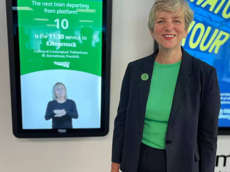 Lilian Greenwood, Nottingham South Member of Parliament smiles in front of L.B. Foster's Inform Totem with BSL.