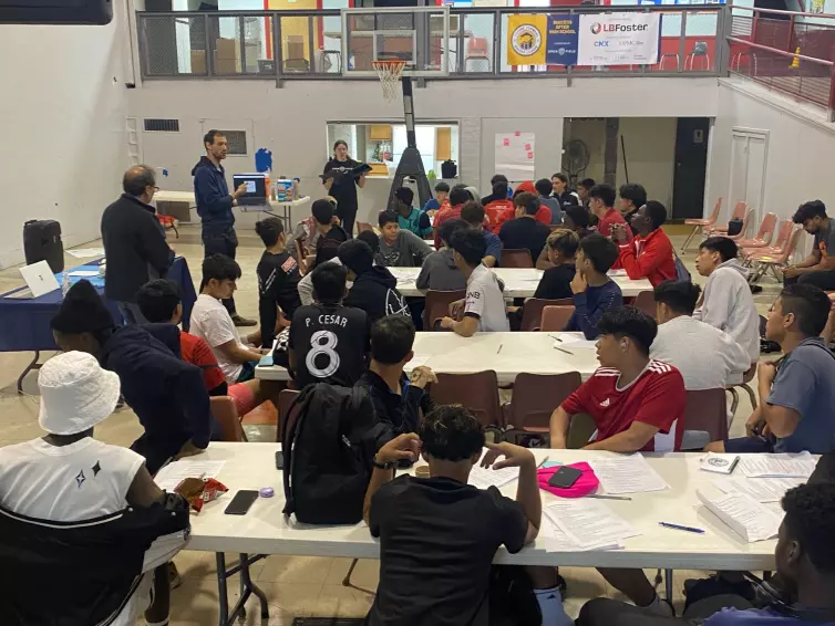 group of boys listening to an enrichment workshop.