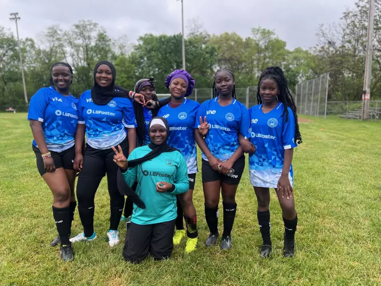 seven girls wearing blue L.B. Foster branded jerseys.