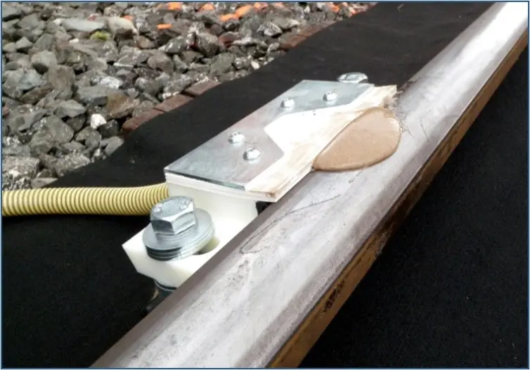 L.B. Foster's ALLEVIATE rail traction enhancer shown on the rail.