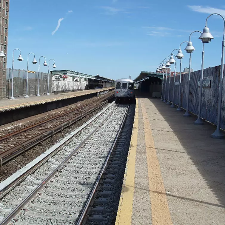 train station showing track and on-coming train.