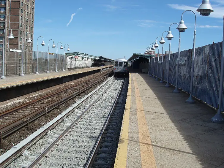 train station showing track and on-coming train.