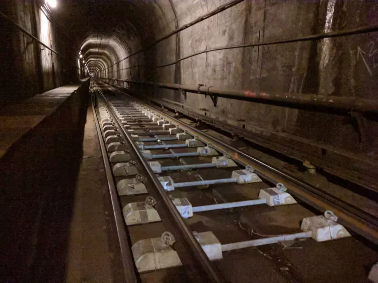 two block rail ties show in tracks inside subway.